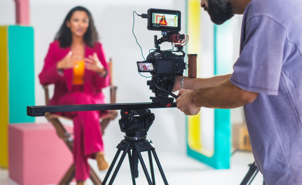 videographer shoot of a woman in a pink suit