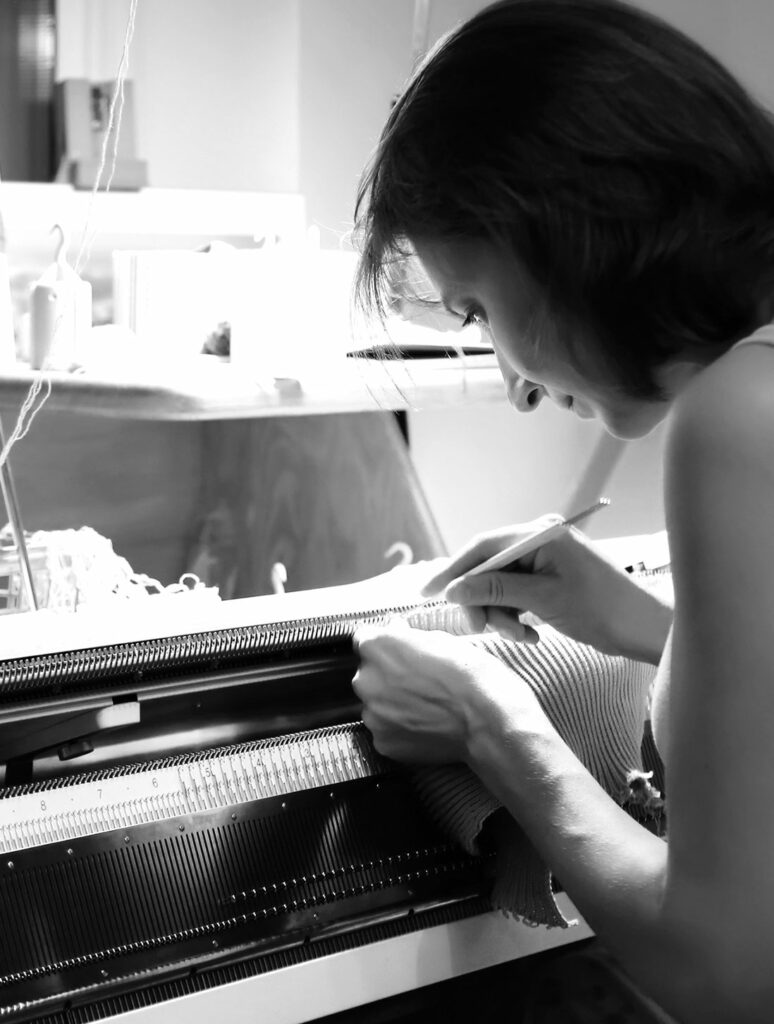 woman threading a knitting machine