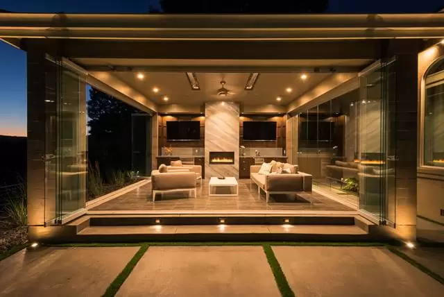 Outdoor patio with glass doors and a fireplace