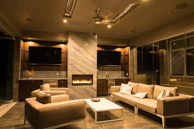 Outdoor patio with glass doors and a fireplace